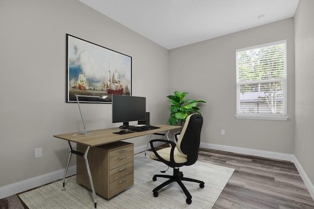 office space featuring light wood-style floors and baseboards