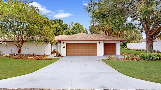 single story home featuring a front lawn and a garage