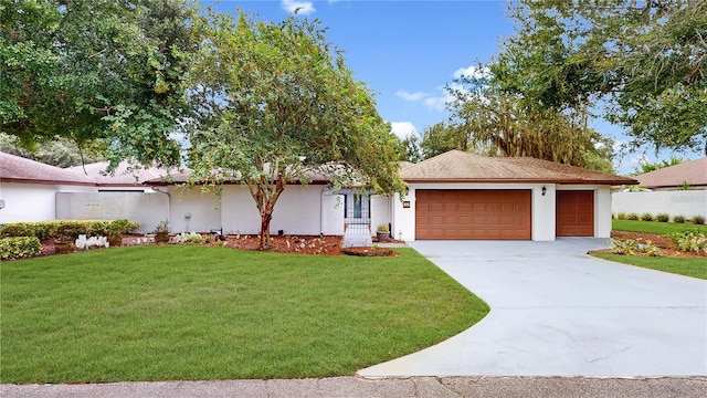 ranch-style house featuring a garage and a front lawn