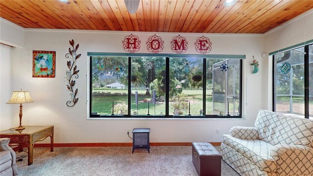 sitting room featuring crown molding, wood ceiling, and carpet flooring