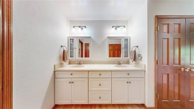 bathroom with vanity and wood-type flooring