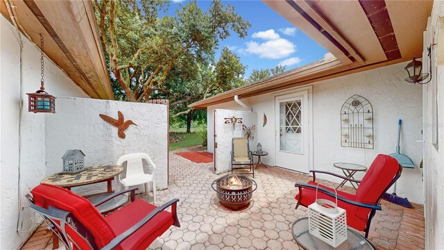 view of patio / terrace featuring an outdoor fire pit