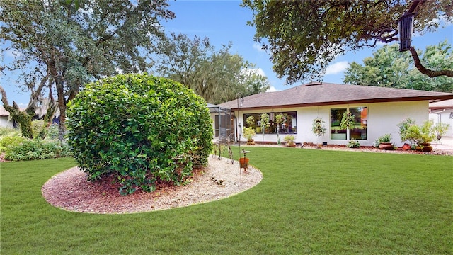 rear view of house featuring a yard