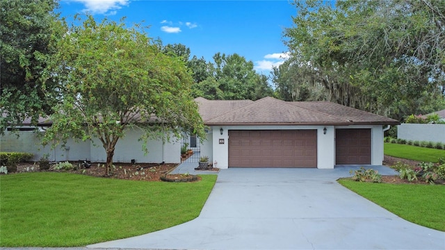 view of front of home featuring a garage and a front lawn