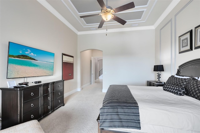 carpeted bedroom with ornamental molding, a raised ceiling, and ceiling fan