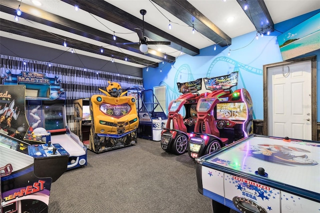 game room with ceiling fan, carpet, and beamed ceiling