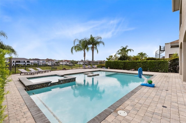 view of swimming pool featuring an in ground hot tub