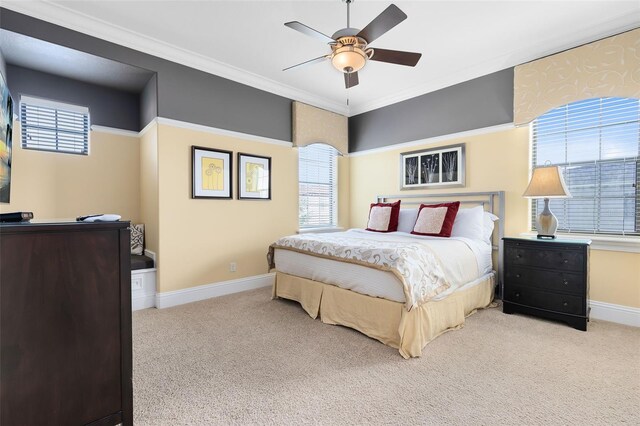 bedroom with ornamental molding, ceiling fan, and light colored carpet