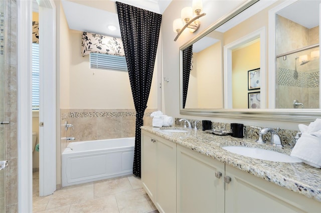 full bathroom with shower with separate bathtub, toilet, vanity, and tile patterned floors