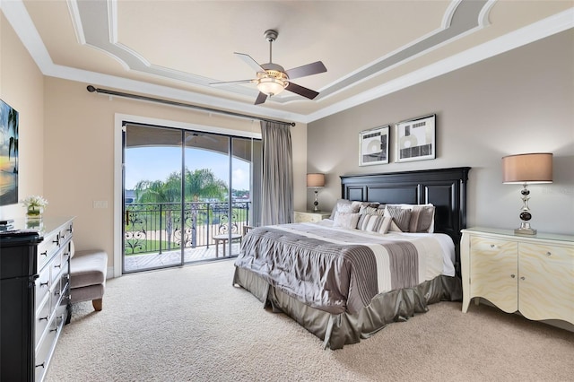 bedroom with a tray ceiling, light carpet, access to exterior, and ceiling fan