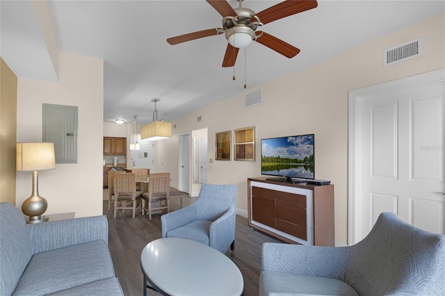 living room featuring ceiling fan, dark wood-type flooring, and electric panel