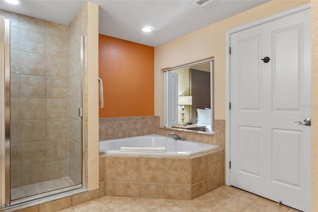 bathroom with tile patterned flooring and shower with separate bathtub