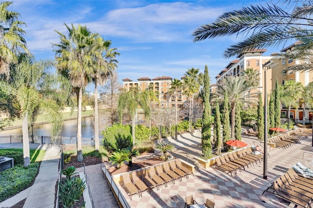 view of property's community with a patio and a water view