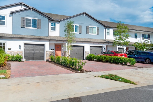 townhome / multi-family property featuring a garage