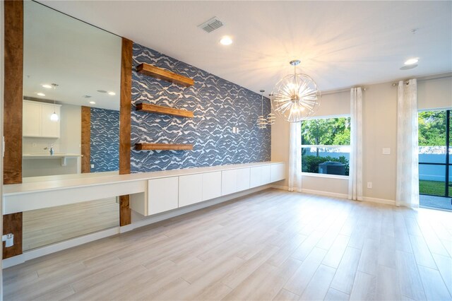 interior space with light hardwood / wood-style flooring and a chandelier