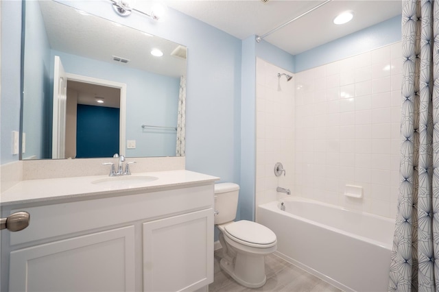 full bathroom with tile patterned flooring, vanity, shower / tub combo with curtain, and toilet