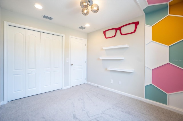 unfurnished bedroom with carpet floors and a closet