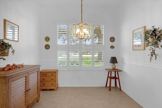 living area featuring light colored carpet and a notable chandelier