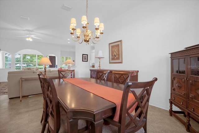 dining space with visible vents and ceiling fan with notable chandelier