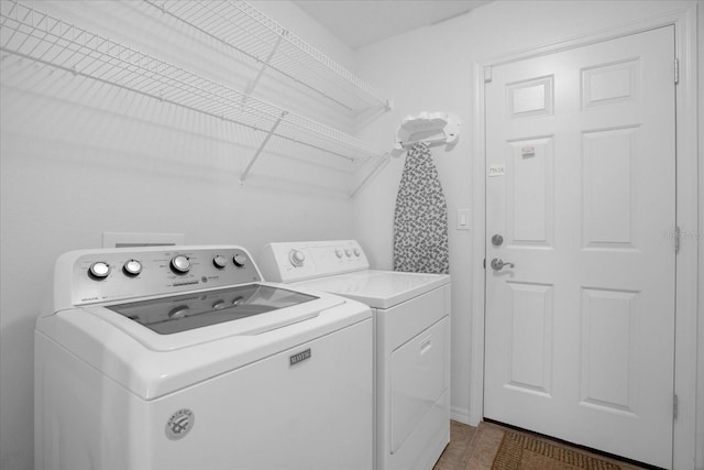 washroom featuring laundry area and washing machine and clothes dryer