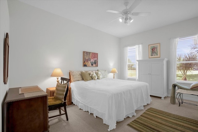 bedroom with ceiling fan and light colored carpet