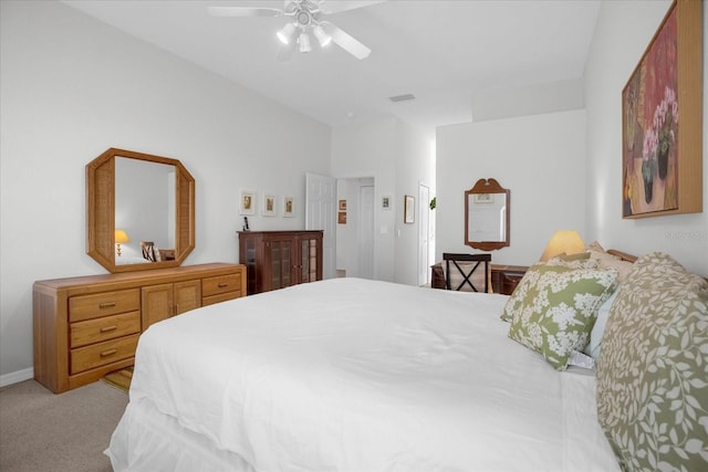 bedroom with light carpet, ceiling fan, visible vents, and baseboards