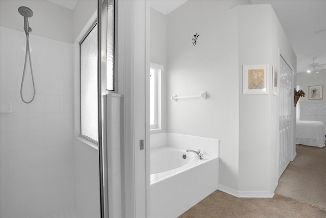 full bathroom featuring a garden tub, tiled shower, connected bathroom, and baseboards