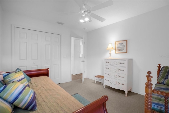 bedroom featuring a closet, visible vents, light carpet, ceiling fan, and baseboards