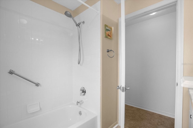 bathroom featuring baseboards and shower / bathtub combination