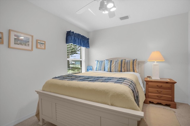 bedroom with light colored carpet, visible vents, ceiling fan, and baseboards