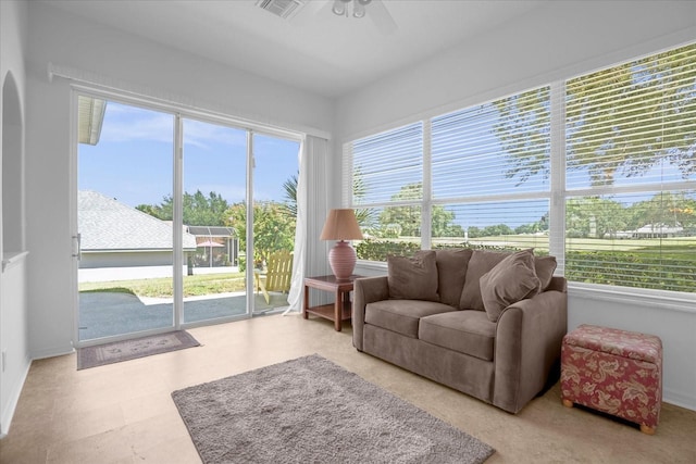 sunroom / solarium featuring visible vents, plenty of natural light, and ceiling fan