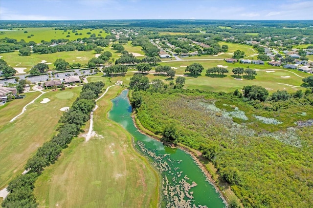 birds eye view of property featuring view of golf course and a water view