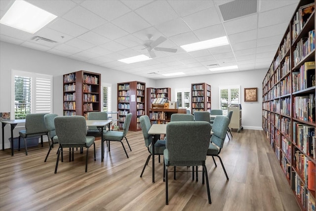 dining room with light wood-type flooring, visible vents, and a drop ceiling