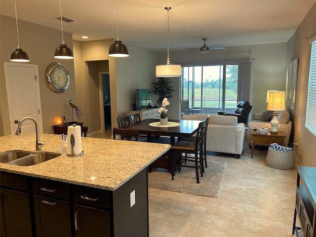 kitchen with light tile patterned flooring, sink, and hanging light fixtures