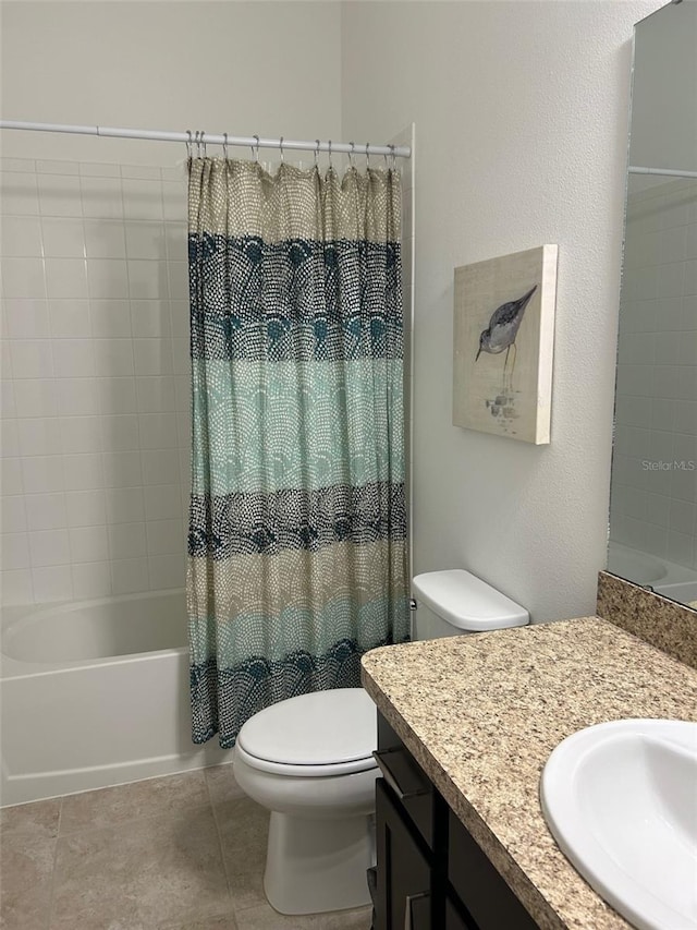 full bathroom featuring tile patterned floors, shower / bath combo with shower curtain, vanity, and toilet