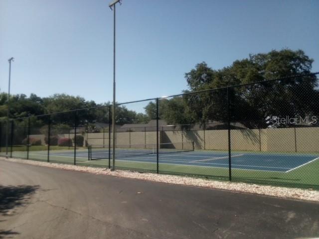 view of tennis court with fence