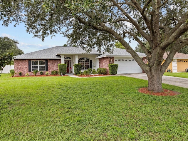 single story home featuring a garage and a front lawn