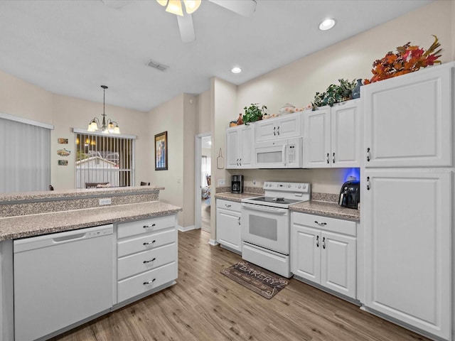 kitchen with white appliances, white cabinetry, light hardwood / wood-style floors, ceiling fan with notable chandelier, and decorative light fixtures