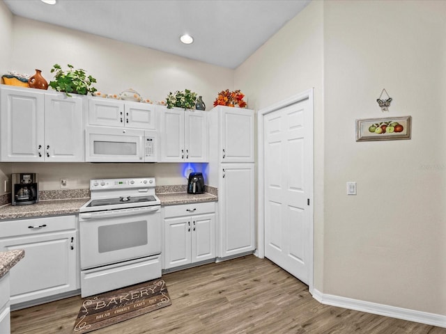 kitchen featuring white cabinetry, white appliances, and light hardwood / wood-style floors