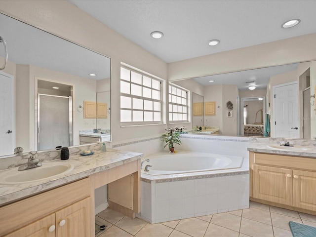 bathroom with tile patterned floors, plus walk in shower, and vanity