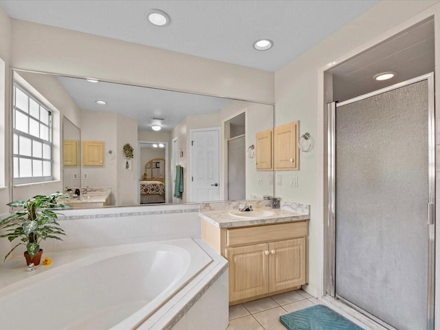 bathroom featuring tile patterned flooring, vanity, and independent shower and bath