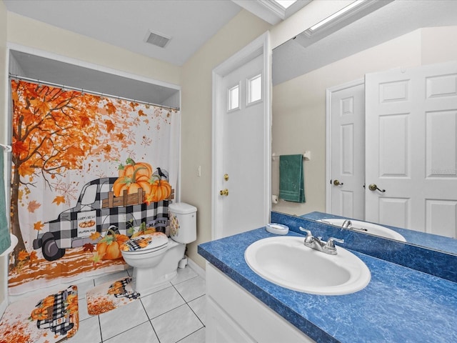 bathroom featuring tile patterned flooring, vanity, and toilet