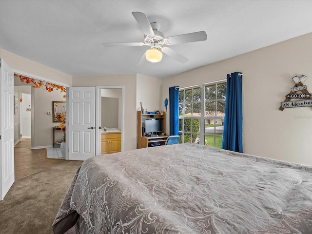 carpeted bedroom with ceiling fan and ensuite bathroom