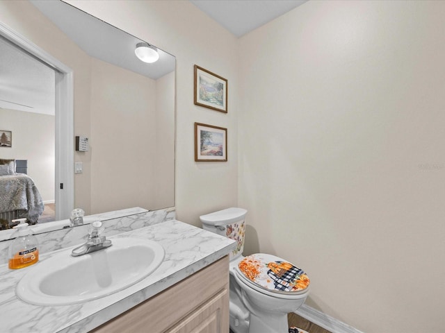 bathroom with vanity, hardwood / wood-style floors, and toilet