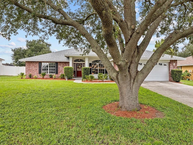 view of front of property with a garage and a front lawn