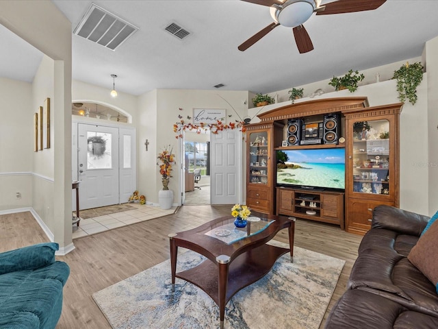 living room with ceiling fan and light wood-type flooring