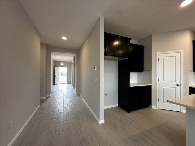 corridor with light hardwood / wood-style floors