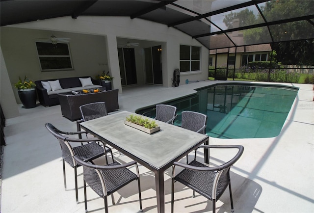 view of swimming pool with a lanai, outdoor lounge area, ceiling fan, and a patio area