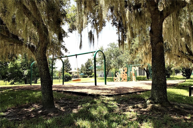 view of home's community with a playground and a yard