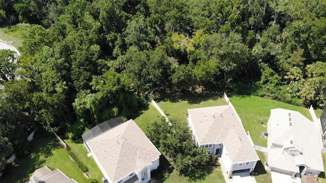 birds eye view of property with a residential view and a view of trees